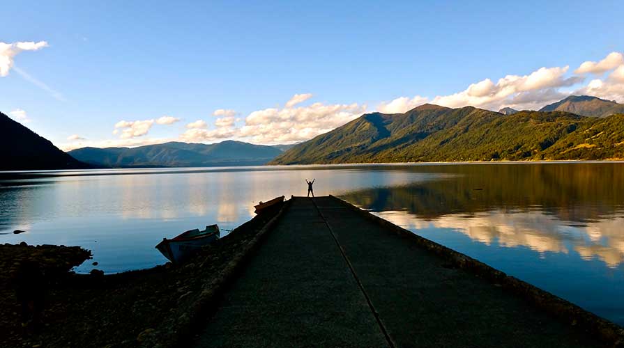 A student in front of a beautiful lake