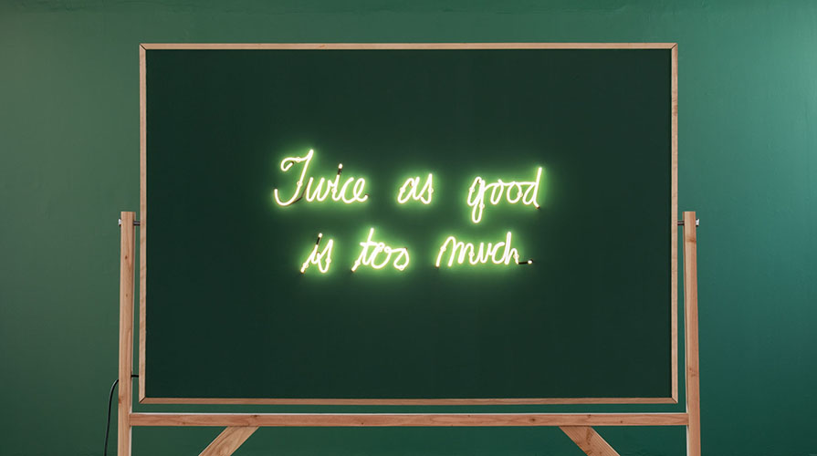 A blackboard with glowing letters that read "Twice as good is too much."