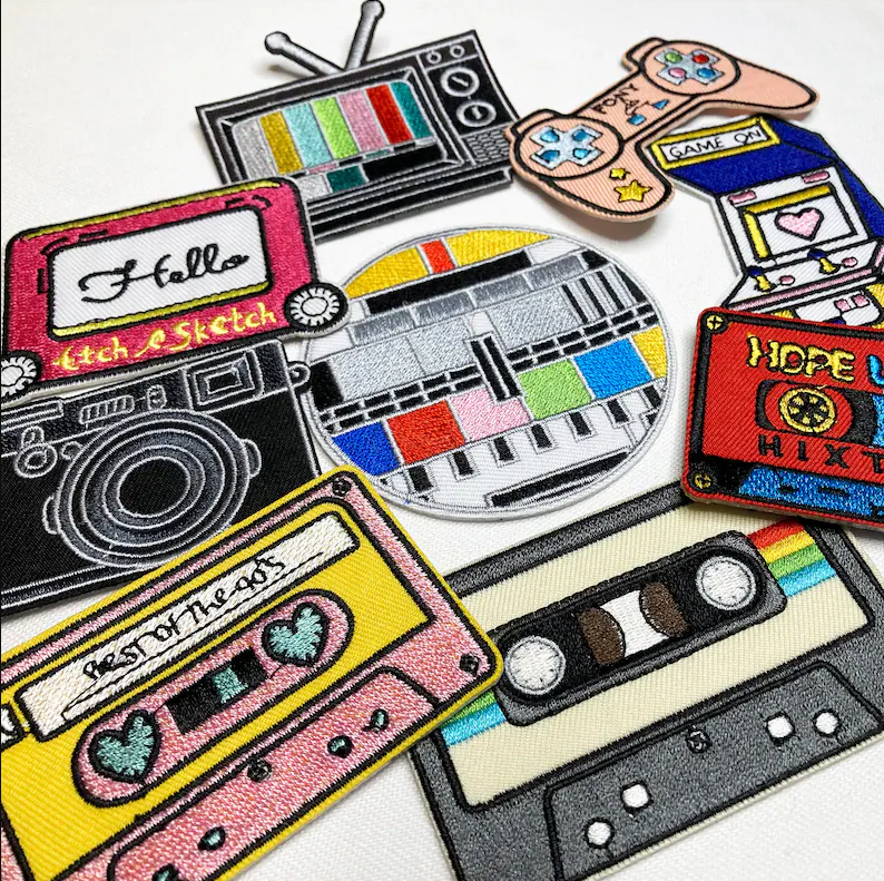 clothing patches in the shape of 80s nostalgia items