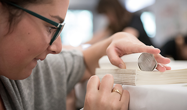 an Occidental College student measuring something in the lab