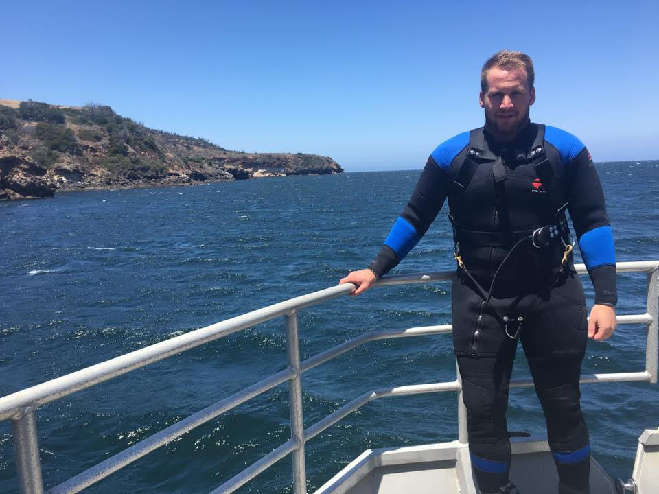 Ryan Freedman on boat with diving gear