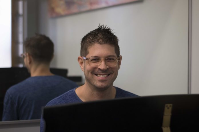 Assistant professor Adam Schoenberg seated at his piano in Booth Hall at Occidental College in Los Angeles on Wednesday, Sep. 11, 2019. Miles Koupal/The Occidental