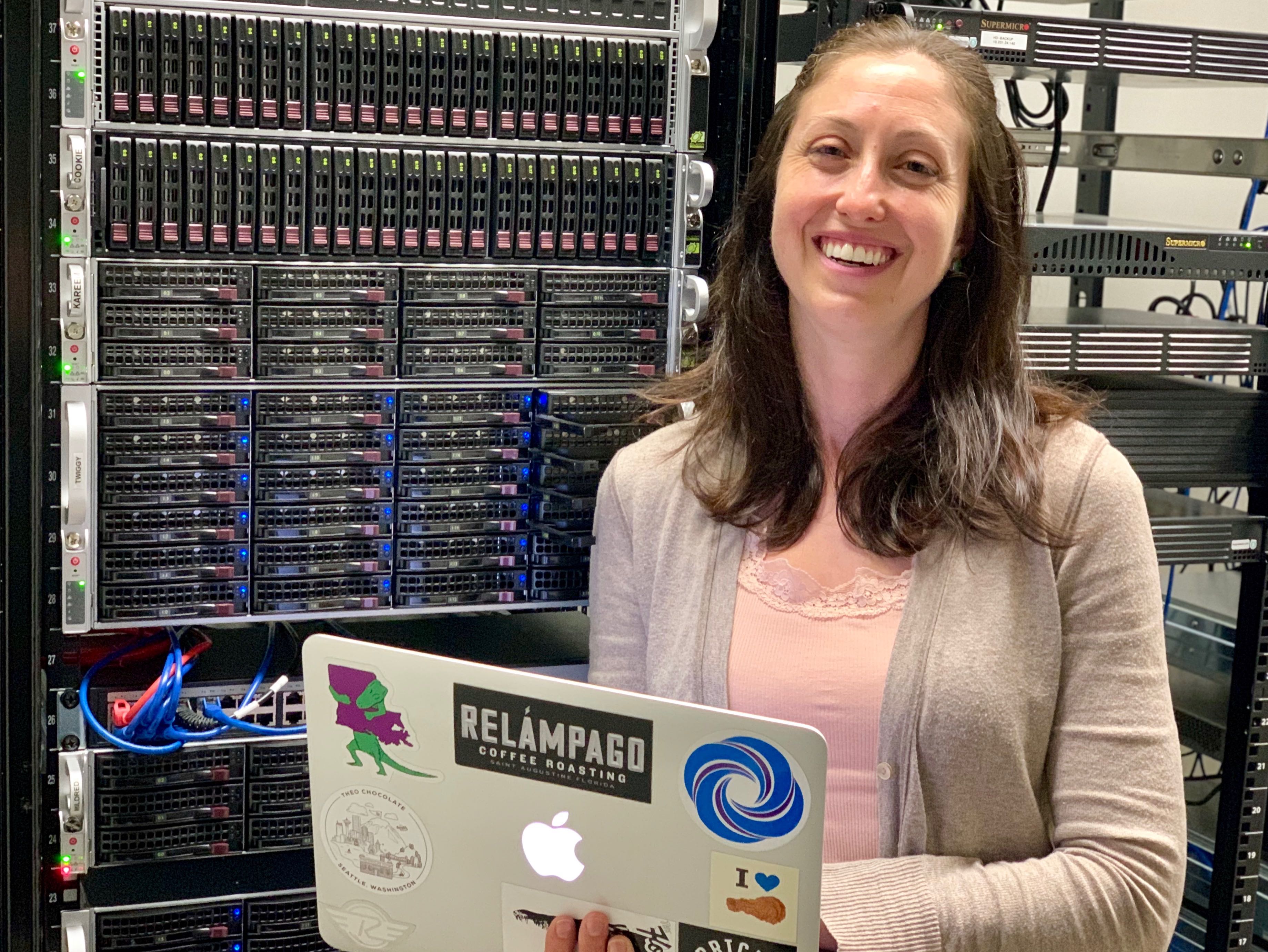 Melissa DeBiasse with laptop in server room