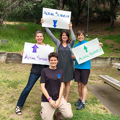 Oxy Biology department members with "Real Scientist" signs