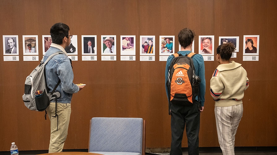 Students looking at student work on the walls in the library