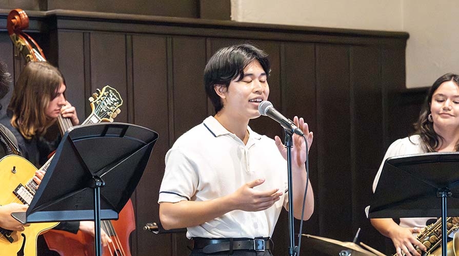 An Occidental College student jazz musician, singing with a mic