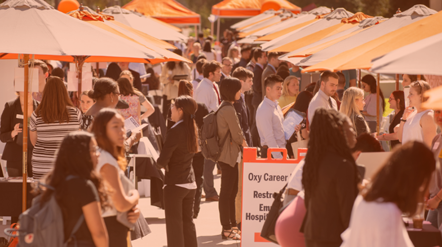 a view of the Occidental College career fair on the Quad on campus, students milling about and booths set up