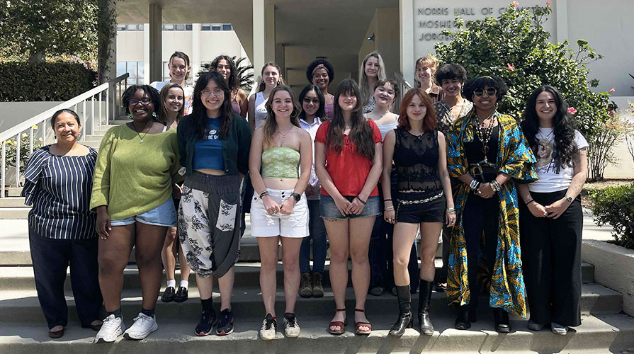 A group of Occidental College students standing on the steps in front of the chemistry building on campus