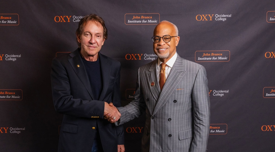 John G Branca '72 shakes hands with Occidental College President Harry J. Elam, Jr.