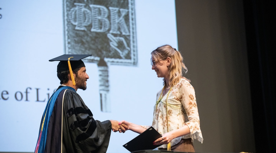 Occidental College professor Jeff Cannon honors a student with membership in PBK