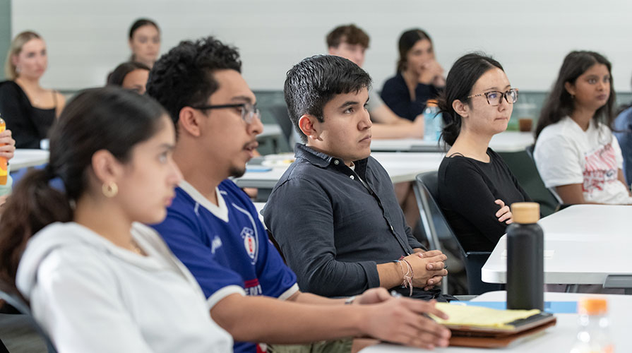 Occidental College students sitting and listening attentively in a classroom