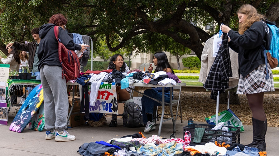 Occidental College students on the quad looking through donated reusable goods