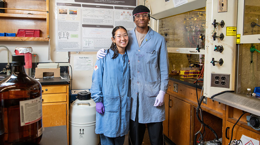 Two Occidental students pose together in the chemistry lab