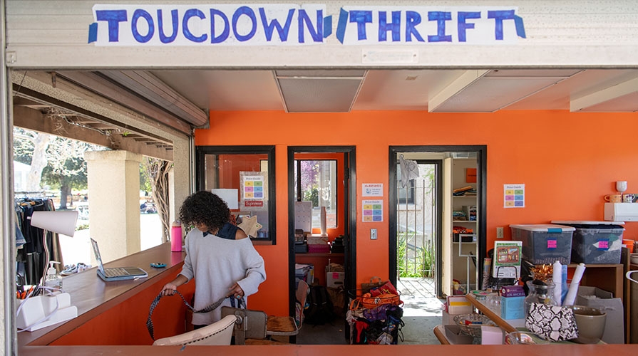 a student working in the Touchdown Thrift store on the Occidental College campus