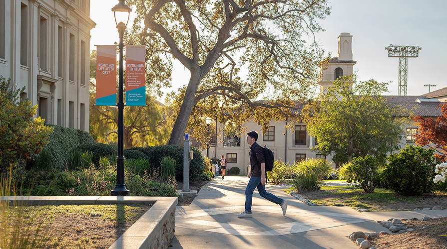 An Occidental student walks outside of Johnson Hall