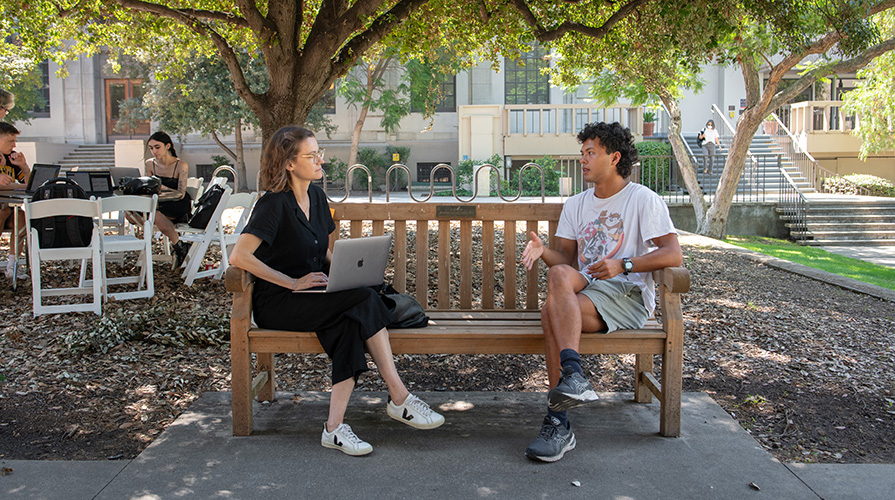 An Occidental professor advises a student in the quad.