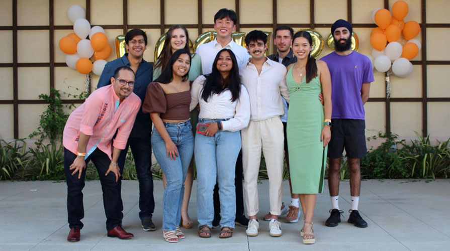 Occidental College economics students standing together in a group smiling