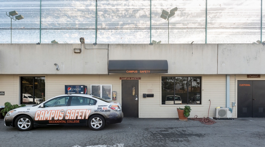 A shot of the campus safety building and a campus safety car