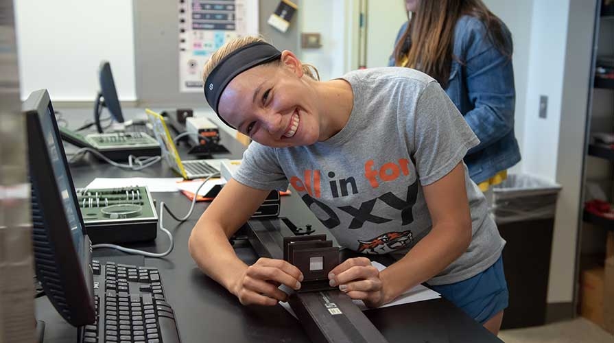 A smiling student working in the physics lab