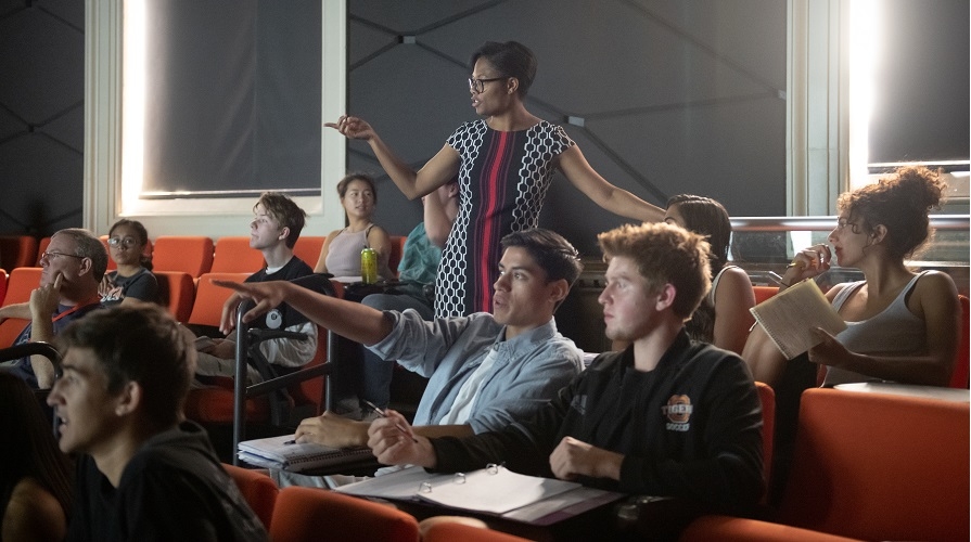 Students in a classroom with a professor lecturing