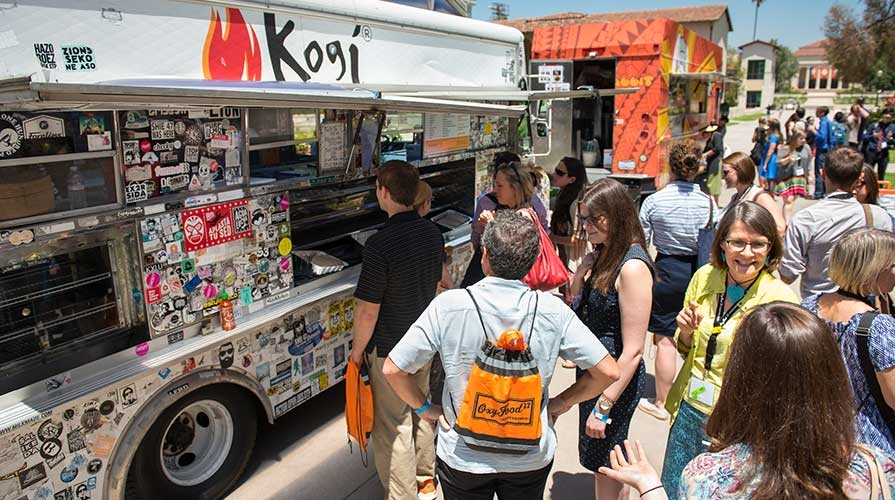 People crowded outside a food truck