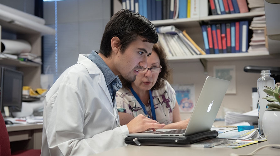 Student in a lab with a mentor