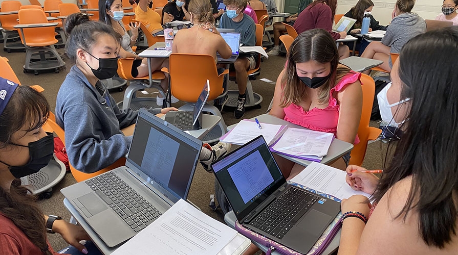 students studying together with their computers