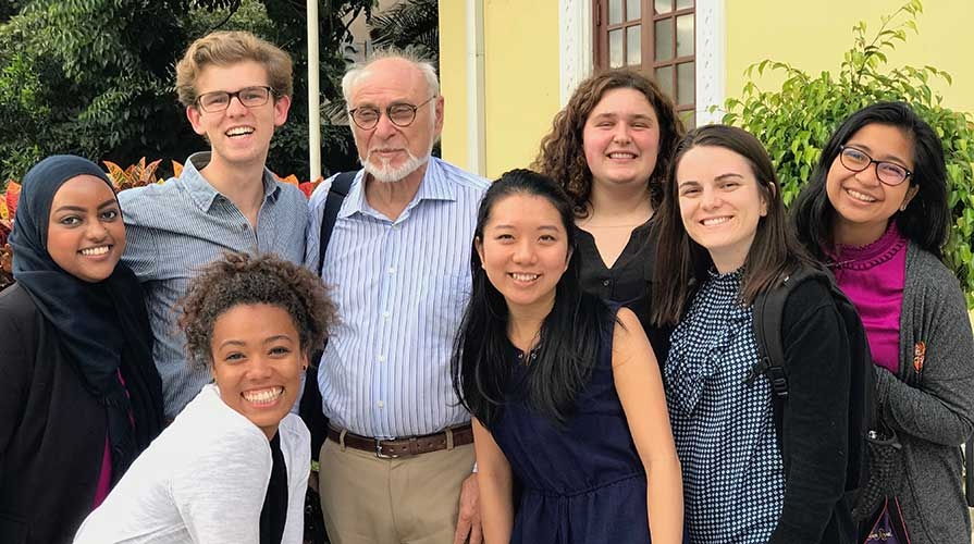 Students gather with a professor