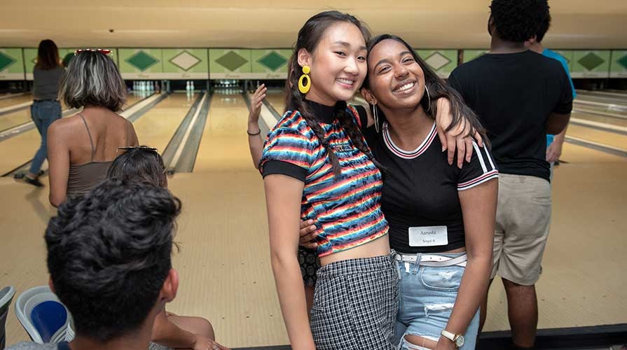 Two happy students pose together