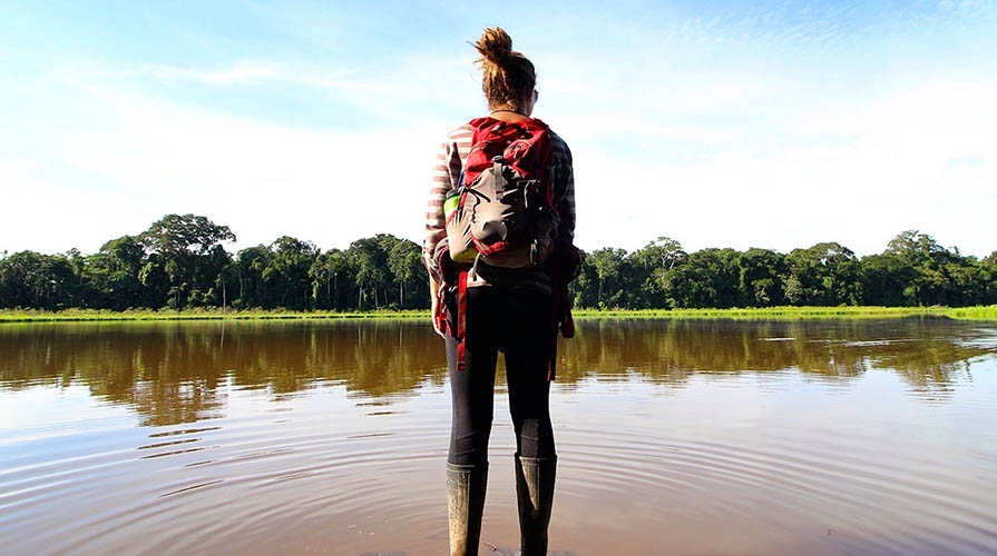 Student standing in a river