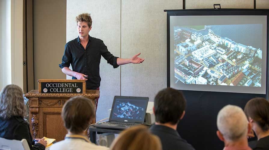 A student presents his international research to a group