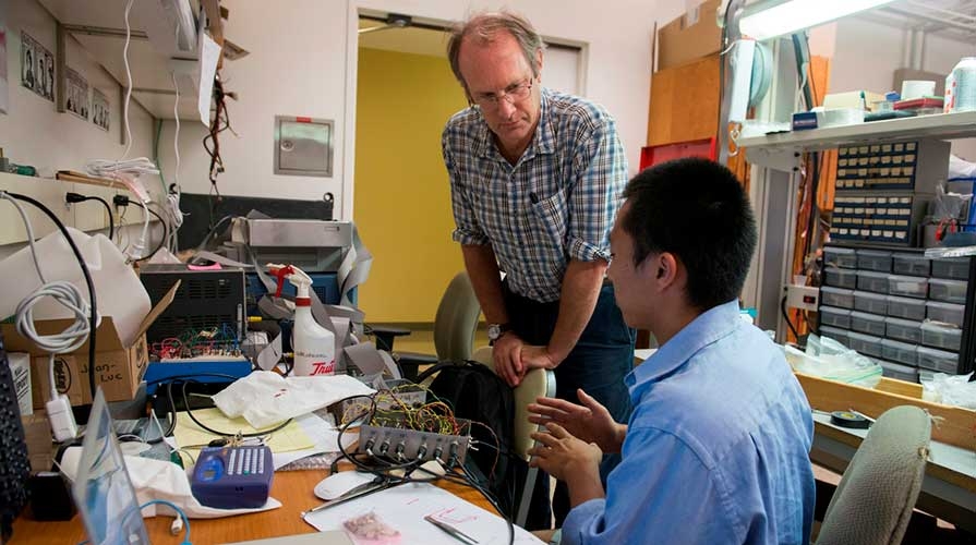 A professor talks to his student worker