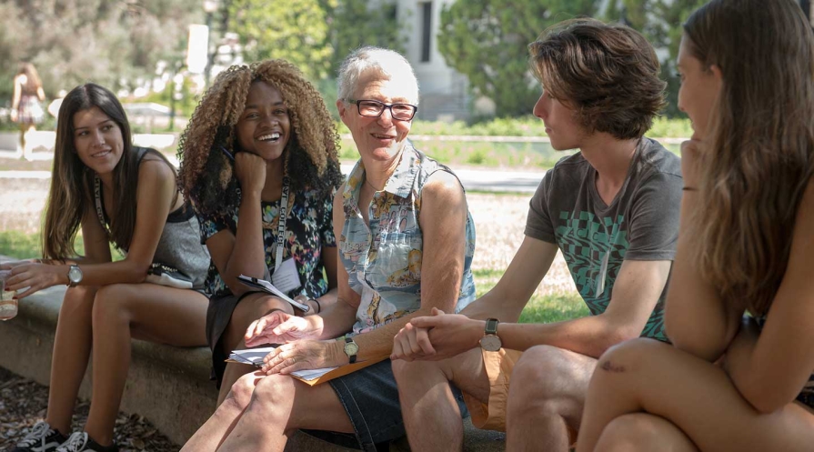 Professor Gretchen North and students talking together