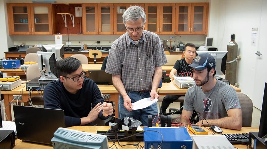 Students and professor work in the lab