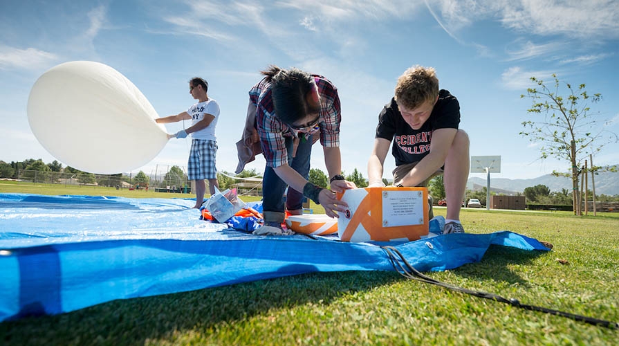 Physics students working on a project outdoors