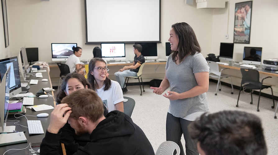 Students engaged in an animated discussion in a Media Arts & Culture class