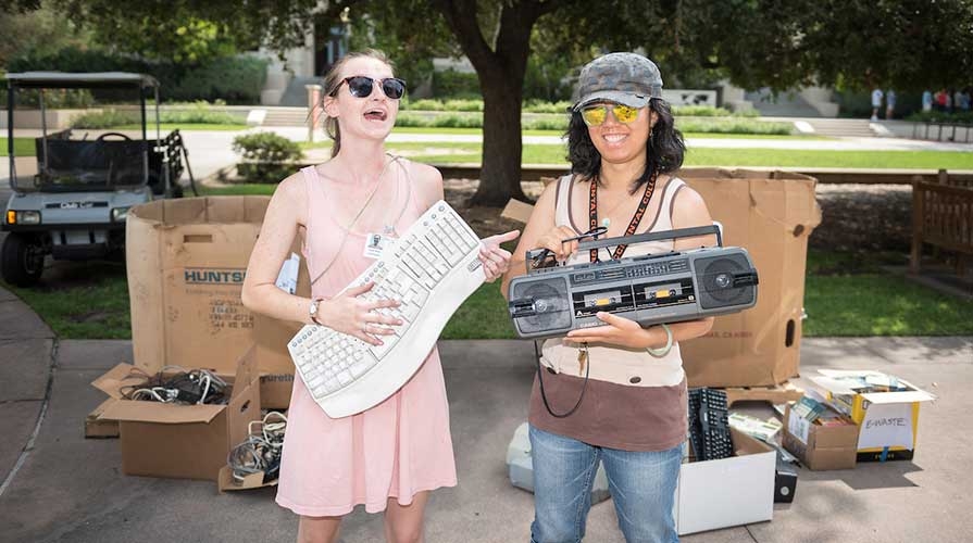 Oxy students holding e-waste at a recycling drive on campus