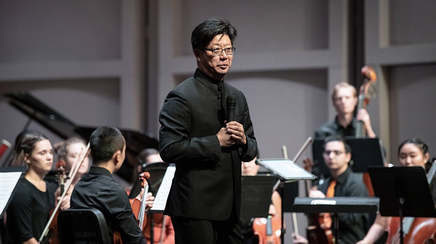 Conductor Chris Kim and the orchestra