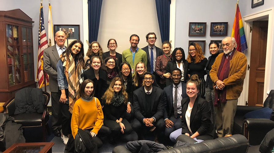 Students pose with California Representative Adam Schiff in his NY office
