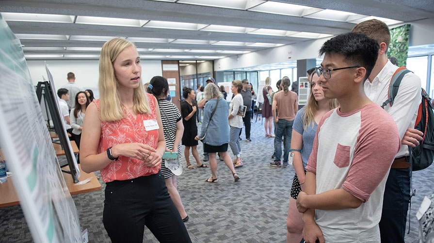 A student presents her research at the 2018 Summer Research Conference