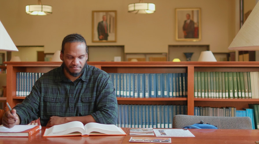 Cameron Peters '18 studying in the library