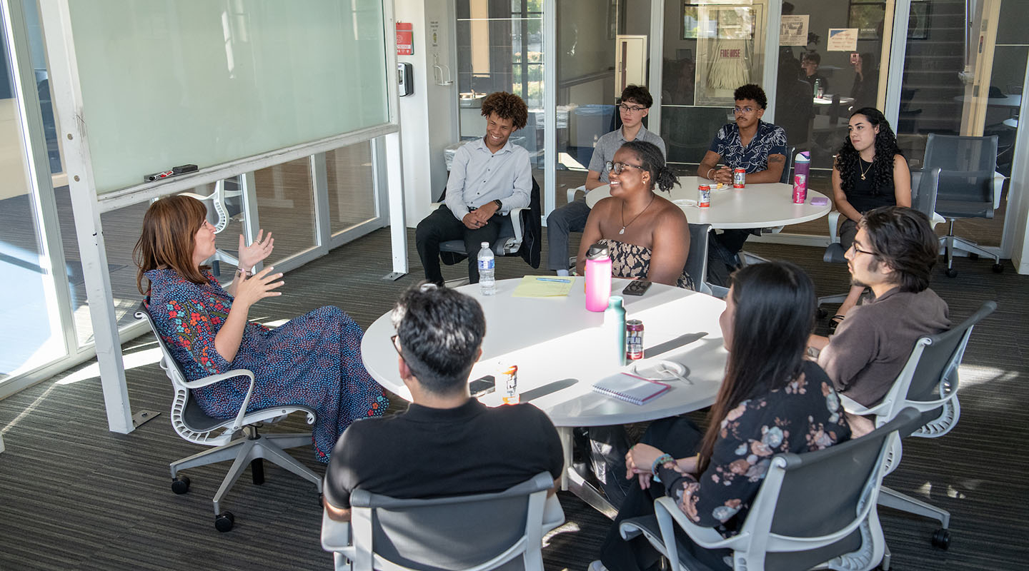 A cohort of Barack Obama Scholars at Occidental College having a lively discussion in a classroom with Sara El-Amine '07