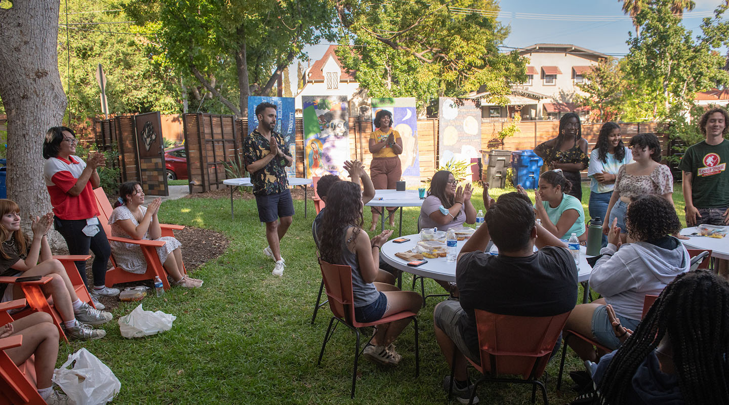 Occidental College students and staff gathered together for a group meal in the backyard of the ICC