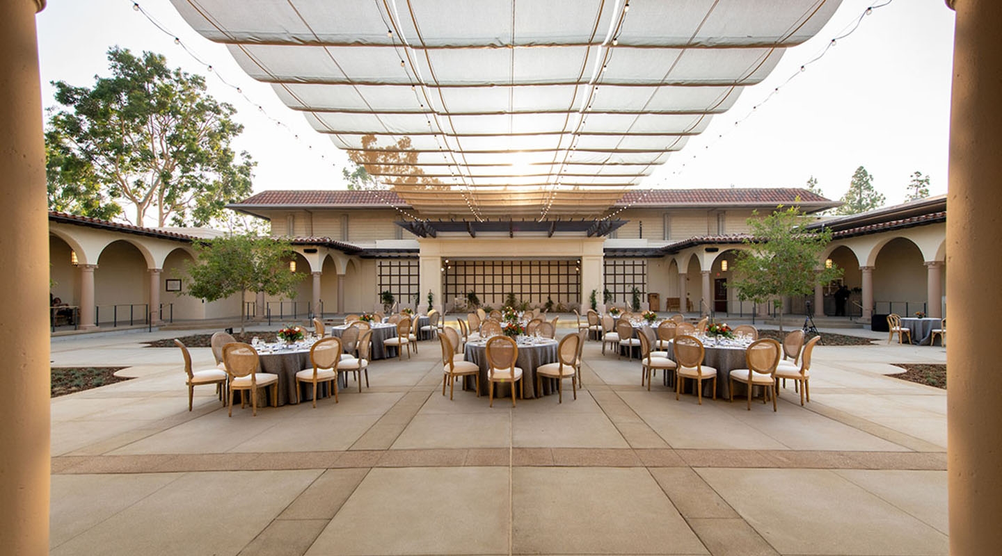 A view of Cannon Plaza set up with tables and chairs and place settings.