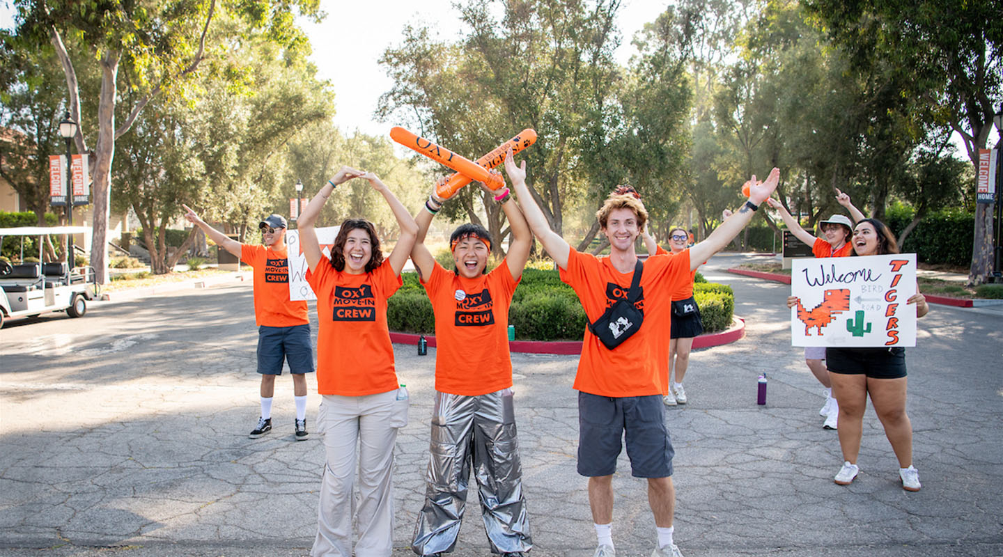 Occidental College students on campus spelling out O-X-Y with their arms