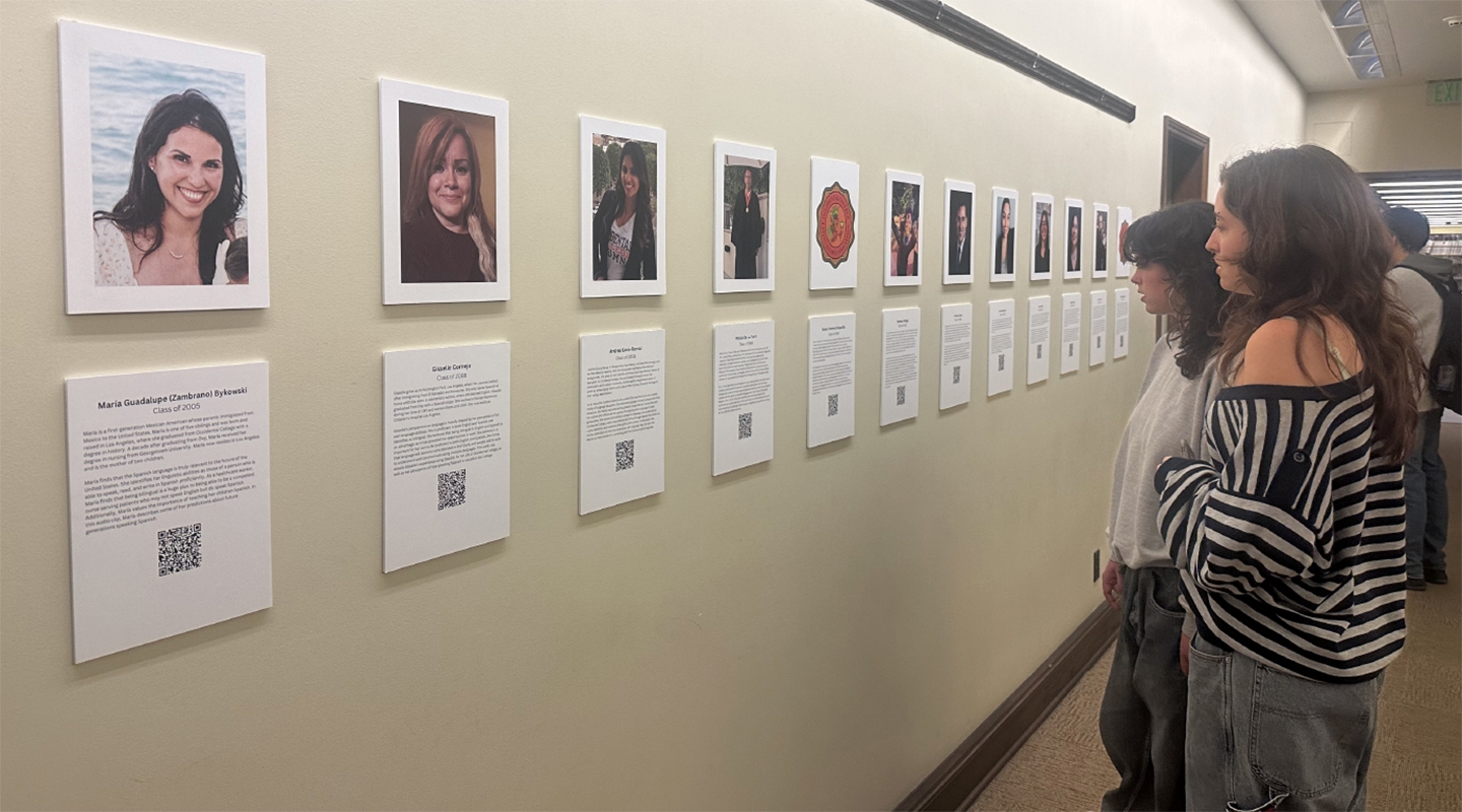 Spectators view the OCLAA oral history gallery in the Academic Commons in February 2024.
