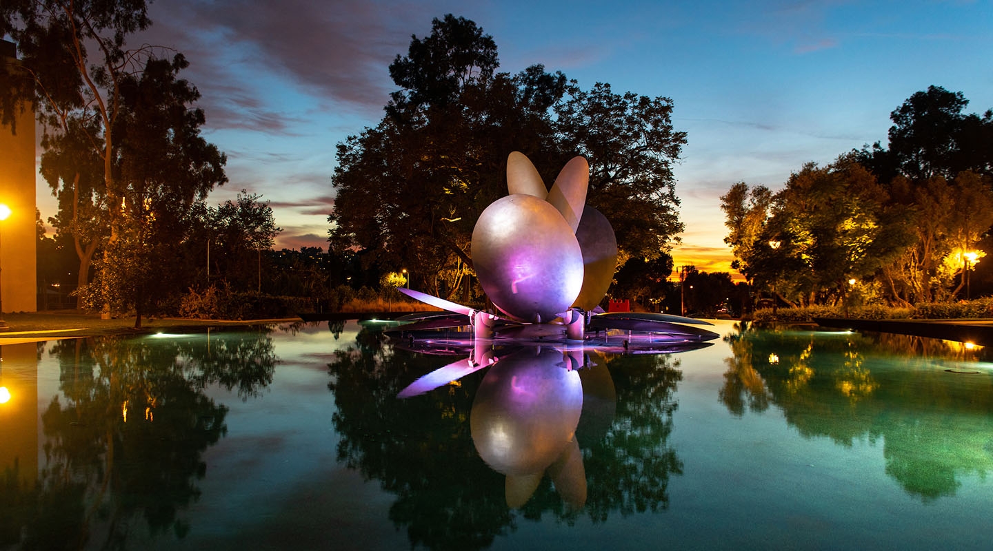 The renovated Gilman Fountain illuminated by a rainbow of colors at dusk