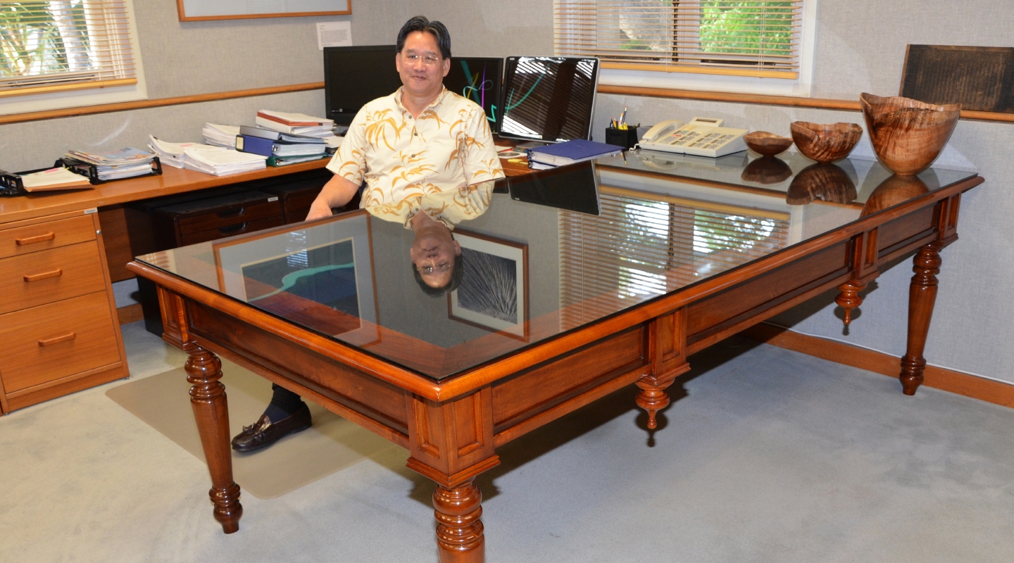 David Louie '73 behind the desk of the attorney general in Hawai'i.