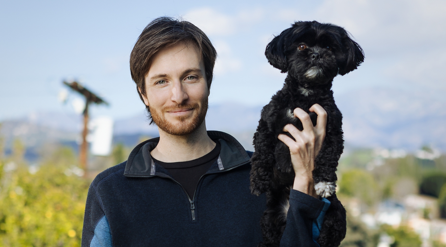 Zak Stoltz '10 with his dog, Boba, at his home in Mount Washington.