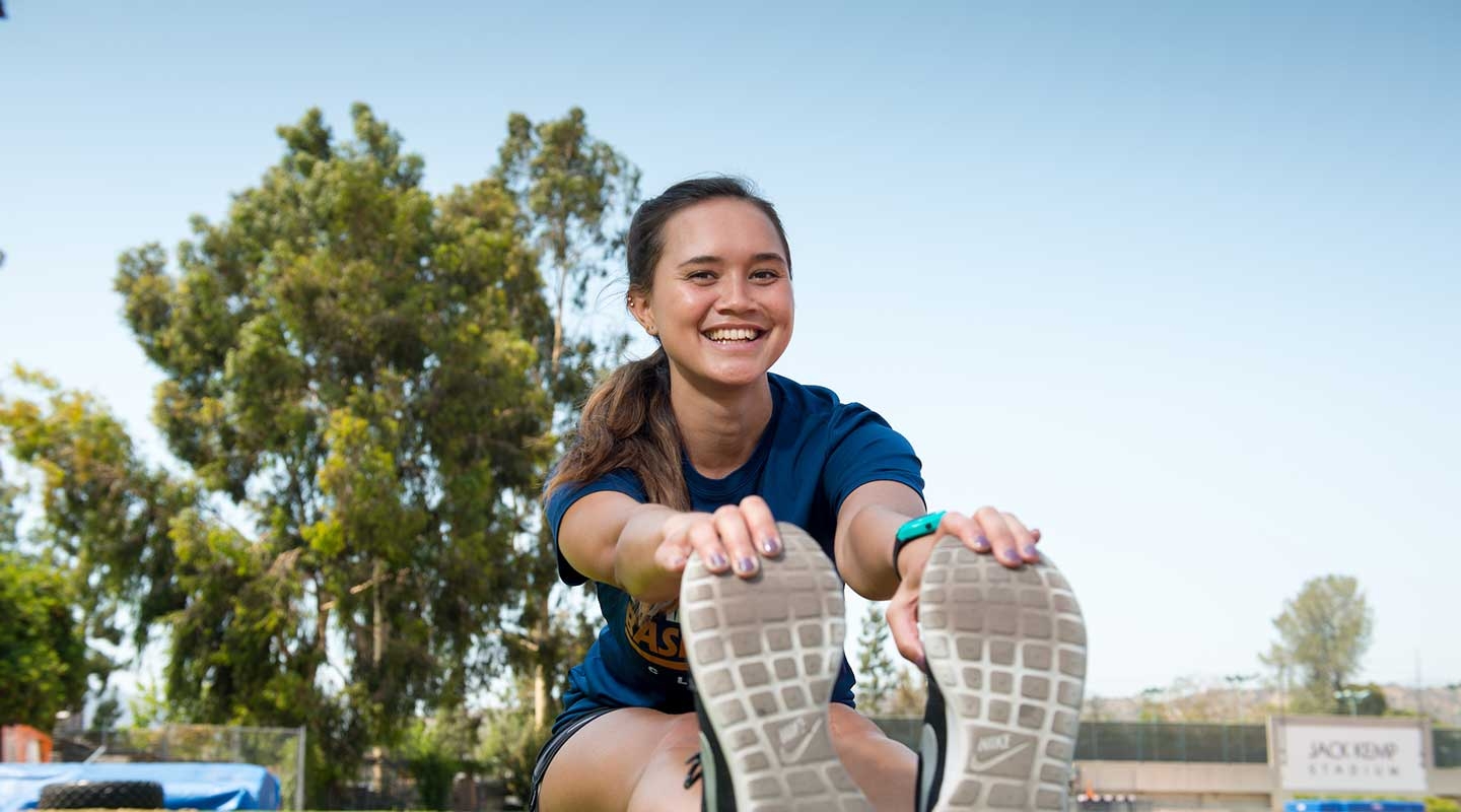 Oxy student stretching on the lawn